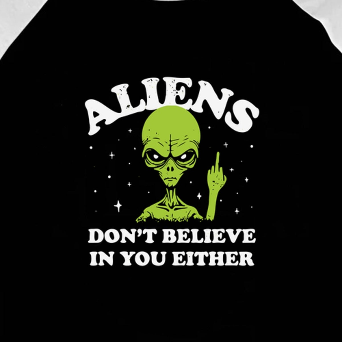 Close-up of the original Aliens Don't Believe in You Either artwork on the black body of the three-quarter-sleeve raglan.