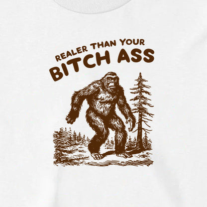 Close-up of the original brown Bigfoot artwork on the white Realer Than Your Bitch Ass long sleeve.